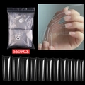 Macro display of 550 pieces transparent long coffin shaped artificial nail tips in 11 sizes - Clear