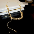 Detailed close-up of golden tassel necklace with willow leaf pendants on a jewelry box - Gold