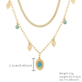 Golden double layer necklace featuring turquoise beads and leaf pendant on white background - Leaf Oval Pendant Necklace
