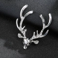 Silver reindeer head brooch pin with sparkling rhinestones on black leather surface - Silver Rhinestone Reindeer