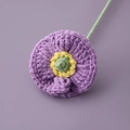 Detailed close-up of a handmade crochet purple poppy flower with intricate knit texture - Purple