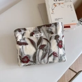 Detailed close-up of floral embroidery and 'simple wish' label on white canvas bag - White with Dark Green and Red Embossed Floral Embroidery