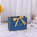 Dark blue paper gift bag with large gold satin bow and golden border details - 28*20*10cm / Blue with Gold Edge + Gold Ribbon