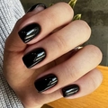 Glossy black square medium-length press-on nails on a natural hand pose for women - Medium Square / Black
