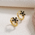 Macro detail of gold flower earrings with black gemstones and hinged clasp design - Black (YH501)