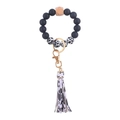 Silicone beaded keychain bracelet with black cow print, wooden bead, and leather tassel - Cow