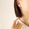Minimalist silver geometric triangle hoop earring worn by model for elegant styling - Pointed Triangle / Silver