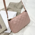 Pink quilted underarm bag with rhombic stitching on gray blazer, elegant shoulder strap - Pink