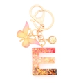 Pink and orange resin letter E keychain with butterfly charm and golden glitter sequins - Letter E
