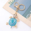 Detail of a golden metal turtle keychain with sparkling blue rhinestones and lobster clasp - Turtle 7 (Blue)
