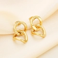 Macro view of gold interlocking geometric earrings on elegant pleated white silk fabric - Irregular Nested Style (KE116222-KFC)