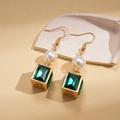 Close-up of elegant gold earrings with white pearls and green square rhinestones - Ear Hook-Green Style