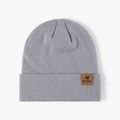 Grey ribbed knit beanie featuring a brown leather patch with METERULE lettering - One Size / Blue Grey