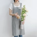 Minimalist grey linen cotton apron for women with wide shoulder straps in a home garden setting - Gray