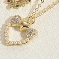 Macro shot of heart pendant with pearl border and micro-pave crystals on gold chain - Bowknot Heart Style (XL2666)
