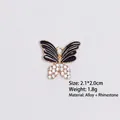 Detail of butterfly pendant with black oil drip wings and white rhinestones, size 2.1x2.0cm - Style 9 Butterfly / Gold