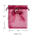 Detailed view of red organza drawstring gift bag with rose bow, size 12x10cm, weight 2.0g - 8x10cm / Burgundy