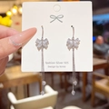 Silver 925 butterfly earrings with long tassel and zircon stones on a white card - Silver Full Zircon Bowknot Tassel (E0044)