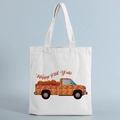 Detail of white canvas tote bag featuring autumn pumpkin print and Happy Fall Y'all text - Happy Fall Text