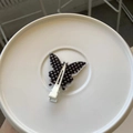 Detail view of a black butterfly hair clip with white polka dots and a metal duckbill clip - Black Polka Dot Butterfly Style (HDJ-11) / White Traceless Clip / White