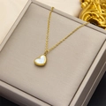 Golden heart necklace featuring white mother of pearl inlay on a jewelry display box - Small Gold White Shell Heart