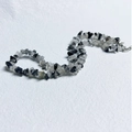 Macro shot of natural irregular black and clear stone chips with a silver lobster clasp - Bracelet / Black Rutilated Quartz