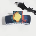 Detail of Halloween hair claw clip featuring moon, bats, and pumpkin on dark blue resin - Blue Yellow Bat Night Sky