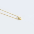 Minimalist gold necklace featuring a polished letter F pendant on a delicate chain - Letter F