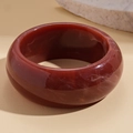 Close-up of deep red resin bangle with marble texture and elegant polished finish - Deep Red Marble