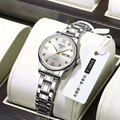 Detailed macro view of the silver stainless steel watch case with white dial and gold indices - Silver Strap White Dial Women's Model