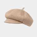 Detailed close-up showing the coarse knit texture and short brim of the octagonal newsboy hat - Camel