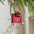 Red metal Santa letter mailbox ornament with wreath and red bow hanging on Christmas tree - Iron Garland Mailbox / Red