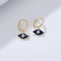 Macro shot of gold Evil Eye drop earrings with blue enamel and sparkling zircon - 925 Silver / Sapphire Blue