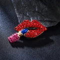Macro shot of stylish red lip and blue lipstick brooch inlaid with shiny rhinestones - Red Lips Lipstick Style / Red Lips