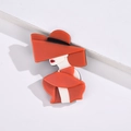 Detailed close-up of a stylish acrylic brooch featuring a lady in a chic red hat and coat - Orange Red