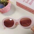 Detailed macro view of pink oval Y2K sunglasses with dark red lenses and retro aesthetic - Pink 11-Pink Frame Oval Retro Sweet Style