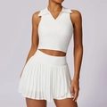 White sleeveless tennis set featuring a collared crop top and high-waisted pleated skirt - S / Swan White