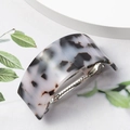 Macro shot of U-shaped acetate hair clip with leopard pattern and silver metal spring - Grey Pattern