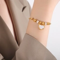 Golden bead bracelet with heart pendant and mother of pearl inlay on model wrist - White Seashell Heart Pendant Slider Style / Gold White Seashell Bracelet (E464)