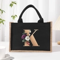 Black canvas tote bag with jute trim and floral gold monogram K design on the front - Bronze Floral Letter K