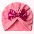 Detail of pink knitted baby turban hat with shiny magenta sequin bow decoration - Pink