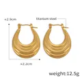 Macro view of gold titanium steel U-shaped earrings with unique wave texture design - Wave Texture Style (F737) / Gold
