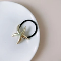 Punk style gold starfish hair tie with black elastic band on white ceramic plate - FA2715 Gold Starfish