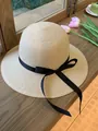 Classic beige straw sun hat with black ribbon bow tie for elegant summer beach protection - M / Beige