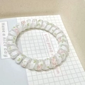 White spiral telephone wire hair tie featuring pink floral patterns and green leaves - Pink Rose