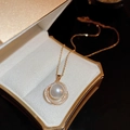 Close-up of a gold pearl pendant with zircon rings in a luxury velvet gift box - Artificial Pearl & Zirconia Pendant Necklace (Gold)