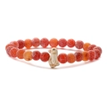 Close-up of orange dragon-vein agate beaded bracelet with a small penguin charm - Red Weathered Stone