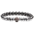 Close-up of beaded stone bracelet with metallic skull charm and red crystal eyes - White Gold Skull