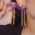 Sparkling copper bow tassel earrings featuring a gradient purple crystal finish - Stud Earrings / Purple Gold Gradient