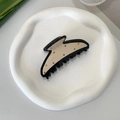 Detailed view of an acetate shark hair claw with colorful dots on a white ceramic plate - Colorful Polka Dot Claw Clip / Black + Beige